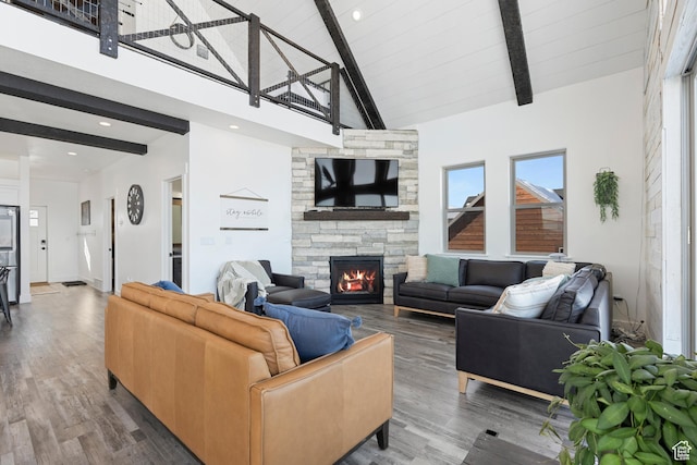 689 N Cambry Dr, Garden City, UT 84028 - living room featuring beam ceiling, a fireplace, wood finished floors, and high vaulted ceiling
