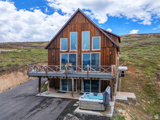 689 N Cambry Dr, Garden City, UT 84028 - rear view of house featuring a hot tub, a deck, and a patio area