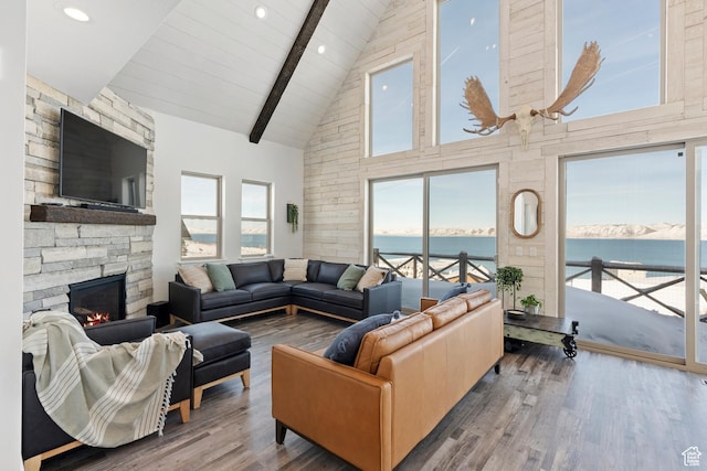 689 N Cambry Dr, Garden City, UT 84028 - living room featuring high vaulted ceiling, a water view, beamed ceiling, a fireplace, and wood finished floors