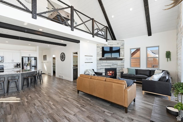 689 N Cambry Dr, Garden City, UT 84028 - living area with high vaulted ceiling, beamed ceiling, a stone fireplace, dark wood-type flooring, and recessed lighting
