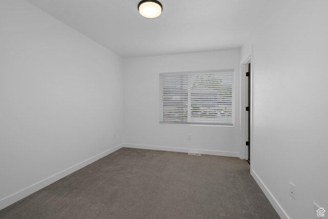 620 N Orchard Dr Unit 11, North Salt Lake, UT 84010 - unfurnished room featuring dark colored carpet and baseboards