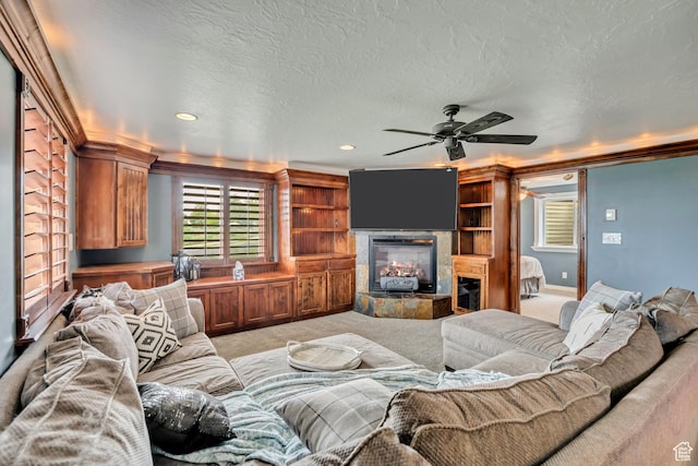 804 E 3300 N, North Ogden, UT 84414 - living area with a ceiling fan, light colored carpet, a tiled fireplace, recessed lighting, and ornamental molding