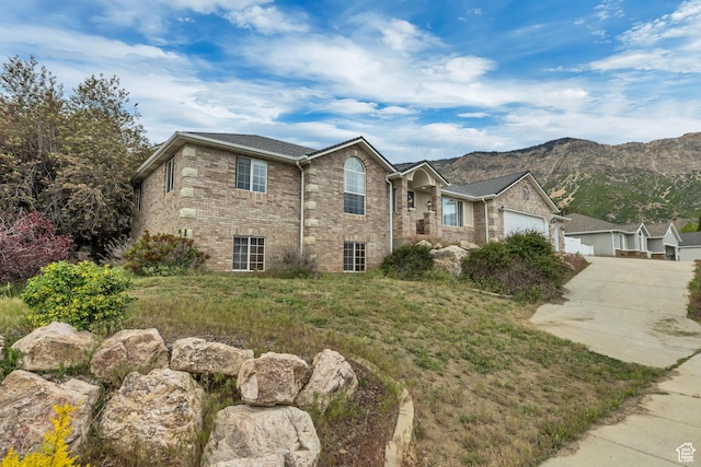 804 E 3300 N, North Ogden, UT 84414 - view of front of house with concrete driveway, brick siding, a garage, and a mountain view