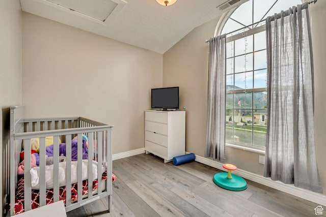 804 E 3300 N, North Ogden, UT 84414 - bedroom with vaulted ceiling, baseboards, wood finished floors, and a crib