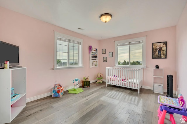 804 E 3300 N, North Ogden, UT 84414 - bedroom featuring multiple windows, wood finished floors, and baseboards