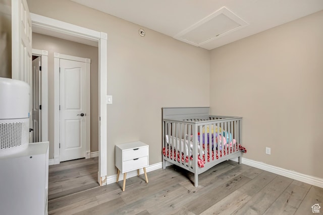 804 E 3300 N, North Ogden, UT 84414 - bedroom featuring light wood-type flooring, baseboards, a nursery area, and attic access