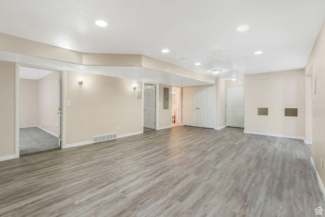 1267 E Hickenlooper Way S, Draper, UT 84020 - unfurnished living room with light wood-type flooring, baseboards, recessed lighting, and electric panel