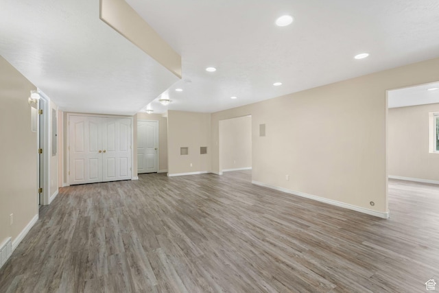 1267 E Hickenlooper Way S, Draper, UT 84020 - unfurnished living room featuring light wood-style floors, baseboards, and recessed lighting