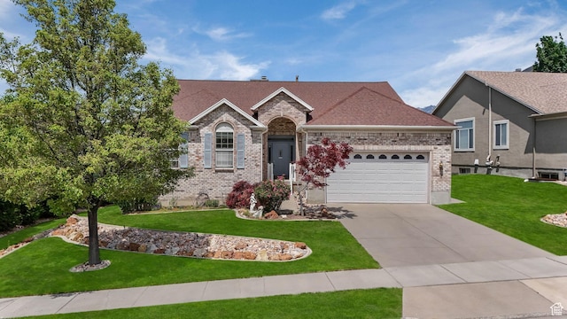 1267 E Hickenlooper Way S, Draper, UT 84020 - view of front of house featuring a front yard, a garage, concrete driveway, and brick siding