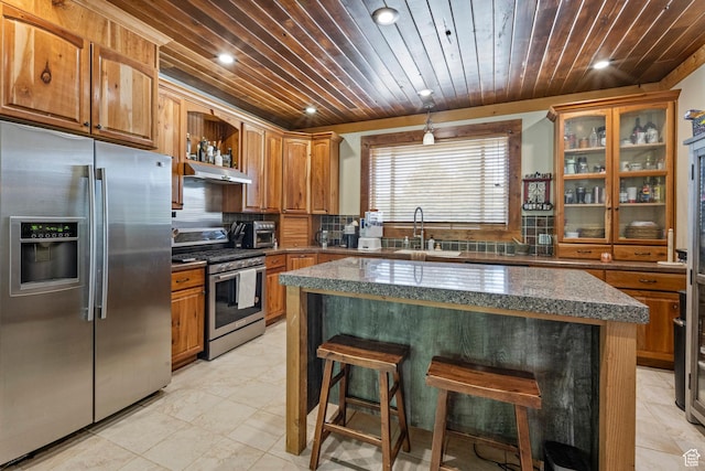 14745 N 8375 E, Spring City, UT 84662 - kitchen featuring stainless steel appliances, a sink, wooden ceiling, a breakfast bar, and brown cabinetry