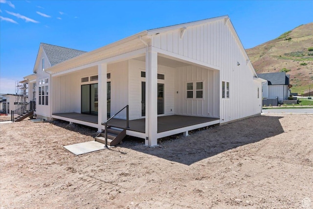 5854 N Fox Canyon Rd, Lehi, UT 84043 - rear view of property with board and batten siding, a mountain view, and a shingled roof