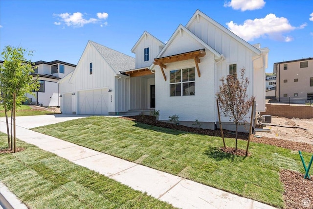 5854 N Fox Canyon Rd, Lehi, UT 84043 - modern inspired farmhouse with board and batten siding, an attached garage, driveway, a front yard, and brick siding