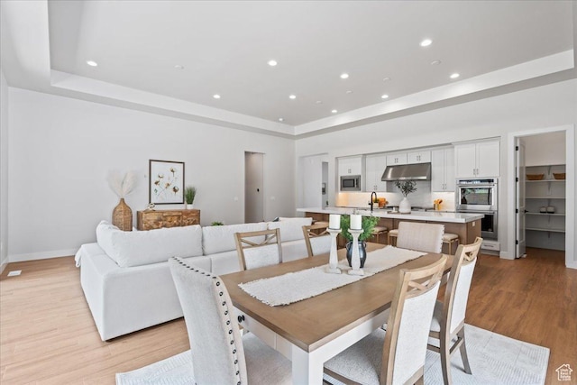 5854 N Fox Canyon Rd, Lehi, UT 84043 - dining room with a raised ceiling, light wood-type flooring, recessed lighting, and baseboards