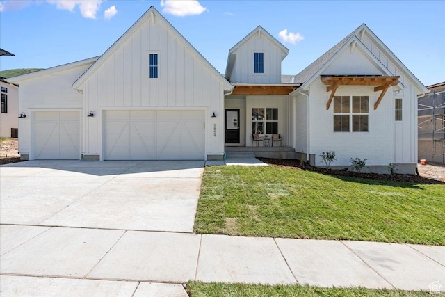 5854 N Fox Canyon Rd, Lehi, UT 84043 - modern inspired farmhouse with board and batten siding, a front yard, an attached garage, driveway, and a porch