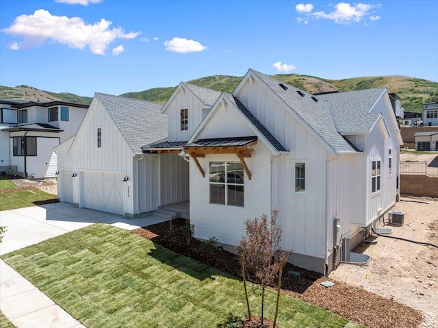 5854 N Fox Canyon Rd, Lehi, UT 84043 - modern farmhouse with board and batten siding, concrete driveway, a standing seam roof, and roof with shingles
