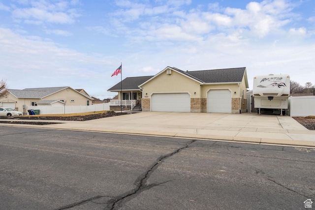 5029 W Copper Meadow Ln S, West Jordan, UT 84088 - view of front of house with an attached garage, concrete driveway, brick siding, and stucco siding