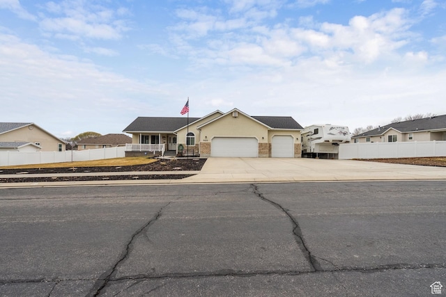 5029 W Copper Meadow Ln S, West Jordan, UT 84088 - view of front of home with driveway, a garage, and stucco siding