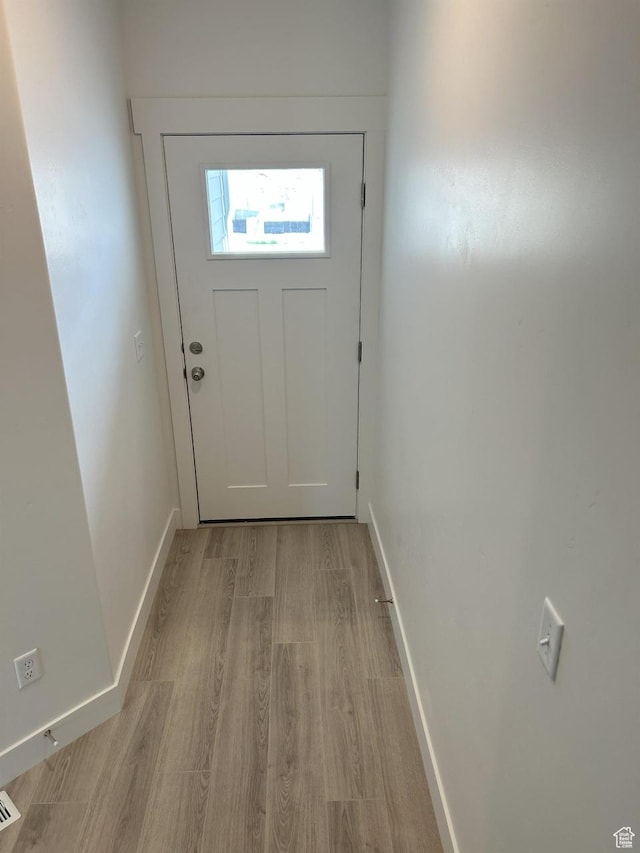 5118 E Lakefield Dr N, Eagle Mountain, UT 84005 - doorway to outside featuring light wood finished floors and baseboards