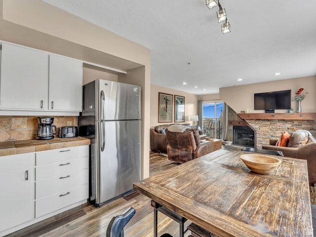 1401 Lowell Ave Unit 31, Park City, UT 84060 - dining space featuring wood finished floors, a stone fireplace, and recessed lighting