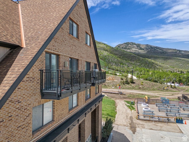 1401 Lowell Ave Unit 31, Park City, UT 84060 - view of side of home featuring a balcony, brick siding, a mountain view, and a shingled roof