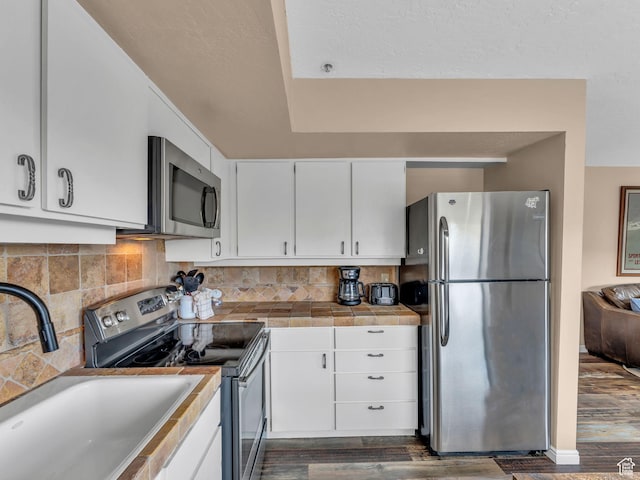 1401 Lowell Ave Unit 31, Park City, UT 84060 - kitchen with stainless steel appliances, dark wood-style flooring, a sink, and white cabinetry