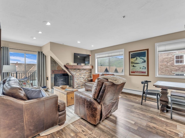 1401 Lowell Ave Unit 31, Park City, UT 84060 - living room featuring hardwood / wood-style flooring, a glass covered fireplace, baseboards, baseboard heating, and recessed lighting