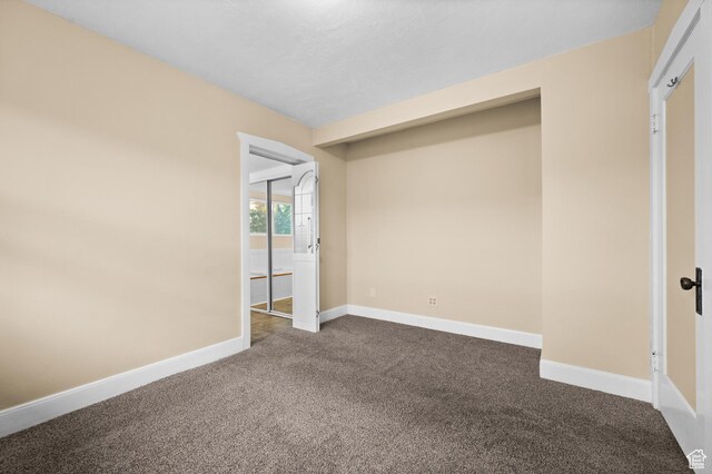1636 S 1400 E, Salt Lake City, UT 84105 - unfurnished bedroom with dark colored carpet, baseboards, and ensuite bathroom