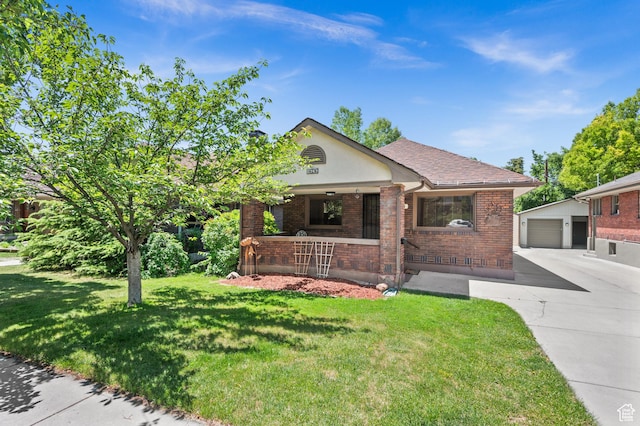 1636 S 1400 E, Salt Lake City, UT 84105 - tudor-style house with an outbuilding, brick siding, a front lawn, concrete driveway, and covered porch