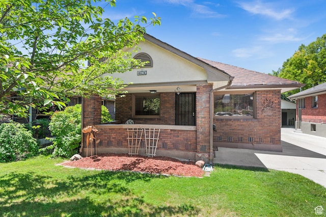 1636 S 1400 E, Salt Lake City, UT 84105 - view of front facade with brick siding, a front yard, and stucco siding