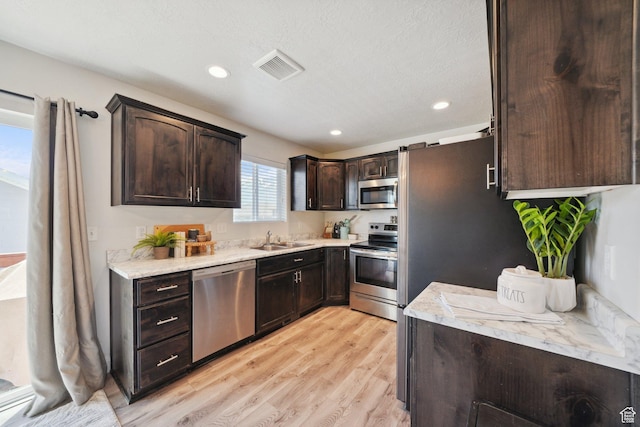 384 N 600 E, Payson, UT 84651 - kitchen with stainless steel appliances, a sink, dark brown cabinetry, light wood-style floors, and recessed lighting
