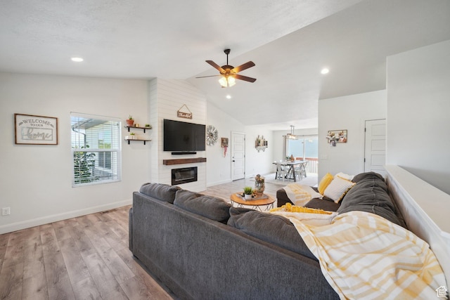 384 N 600 E, Payson, UT 84651 - living area featuring a ceiling fan, light wood-type flooring, vaulted ceiling, a fireplace, and baseboards