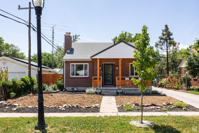 1217 Talisman Dr, Salt Lake City, UT 84116 - bungalow with a chimney, covered porch, brick siding, and a shingled roof