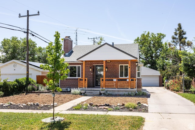 1217 Talisman Dr, Salt Lake City, UT 84116 - bungalow-style home with a porch, a detached garage, brick siding, roof with shingles, and an outbuilding