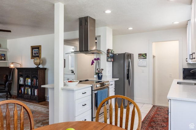 1217 Talisman Dr, Salt Lake City, UT 84116 - kitchen featuring island range hood, stainless steel appliances, white cabinets, light countertops, and a sink