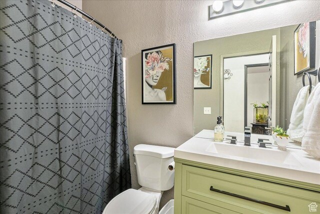 1687 Kylee Ln, Ogden, UT 84404 - full bathroom featuring a textured wall, toilet, vanity, and a shower with curtain