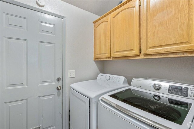1687 Kylee Ln, Ogden, UT 84404 - laundry room featuring separate washer and dryer and cabinet space