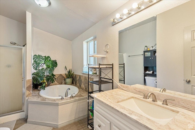 1687 Kylee Ln, Ogden, UT 84404 - bathroom featuring a shower stall, toilet, a bath, vanity, and vaulted ceiling