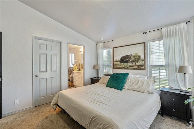 1687 Kylee Ln, Ogden, UT 84404 - bedroom with vaulted ceiling, light colored carpet, ensuite bath, and baseboards