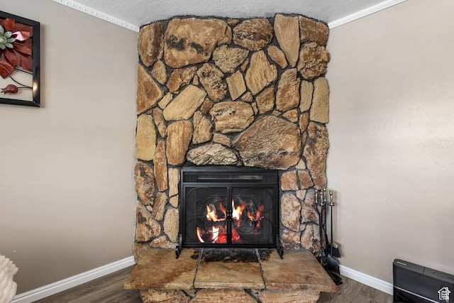 8265 S 3450 W, West Jordan, UT 84088 - detailed view of wood finished floors, baseboards, a stone fireplace, a textured ceiling, and ornamental molding