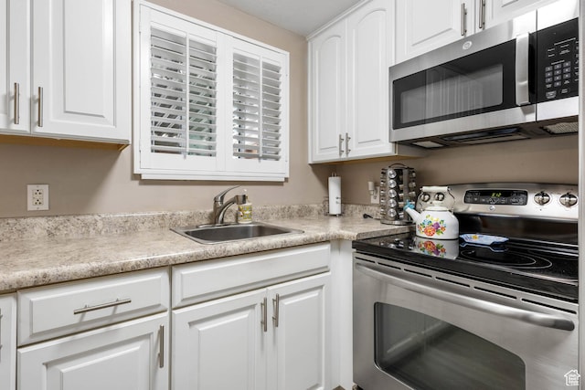 8265 S 3450 W, West Jordan, UT 84088 - kitchen with stainless steel appliances, a sink, and white cabinetry