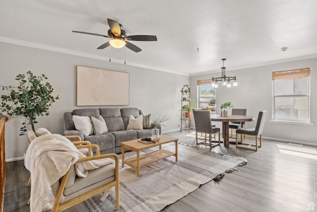 4478 S Balmoral Way, West Valley City, UT 84119 - living room featuring a chandelier, ceiling fan, light wood-type flooring, ornamental molding, and baseboards