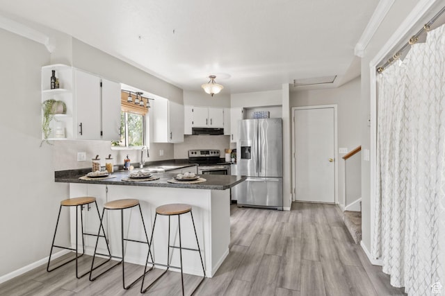 4478 S Balmoral Way, West Valley City, UT 84119 - kitchen with stainless steel appliances, open shelves, extractor fan, dark countertops, and a peninsula
