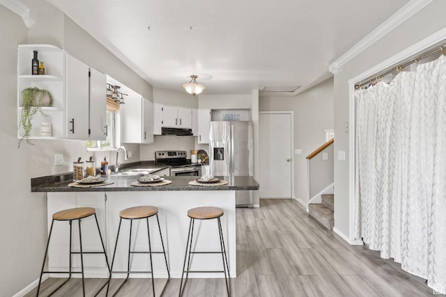 4478 S Balmoral Way, West Valley City, UT 84119 - kitchen with appliances with stainless steel finishes, a sink, open shelves, exhaust hood, and a peninsula
