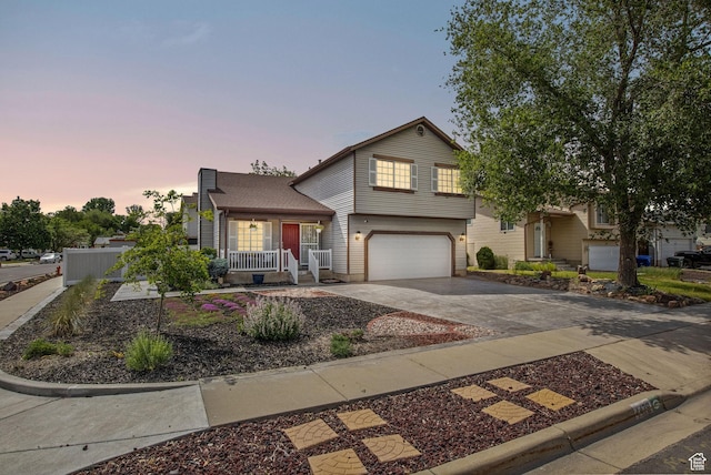 4478 S Balmoral Way, West Valley City, UT 84119 - view of front facade featuring an attached garage, concrete driveway, and covered porch