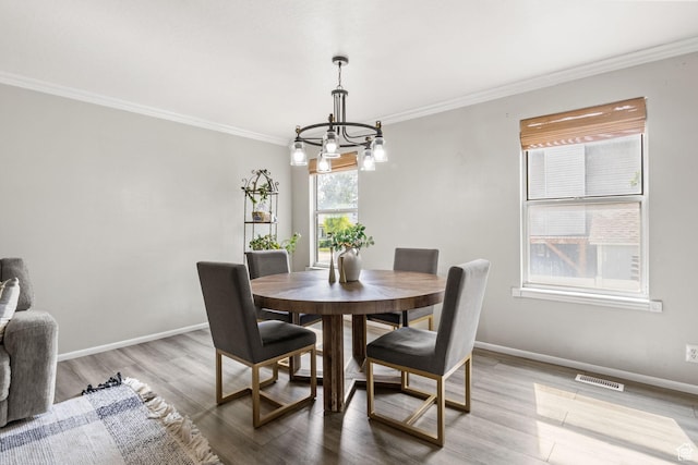 4478 S Balmoral Way, West Valley City, UT 84119 - dining room with ornamental molding, a chandelier, wood finished floors, and baseboards