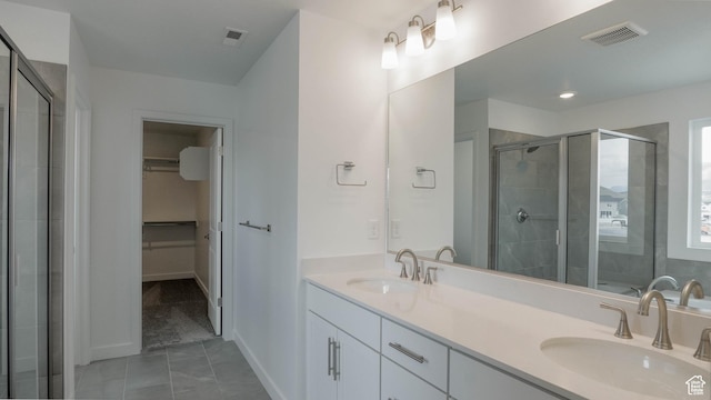 5502 N Trailside Unit 503, Eagle Mountain, UT 84005 - full bathroom featuring a spacious closet, double vanity, a stall shower, and baseboards