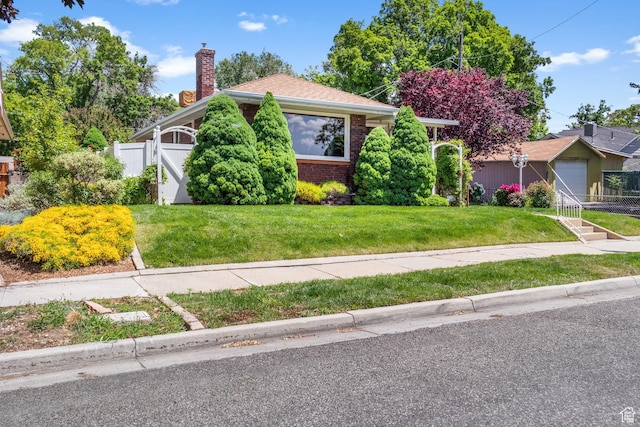 1979 S 600 E, Salt Lake City, UT 84105 - view of front facade with brick siding, a chimney, and a gate