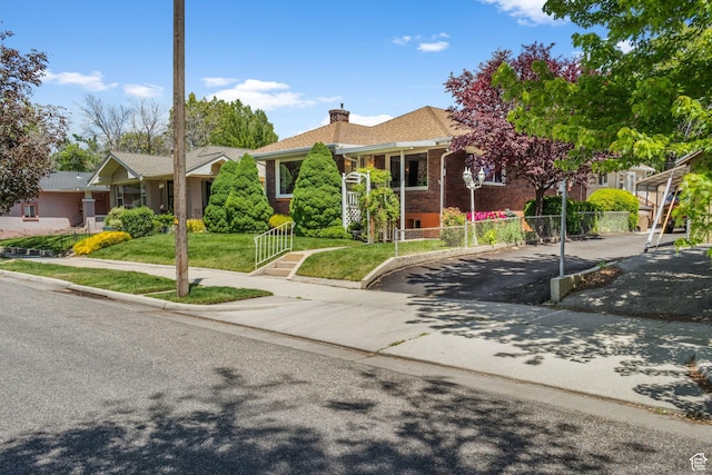 1979 S 600 E, Salt Lake City, UT 84105 - view of front of house with brick siding, a chimney, and driveway