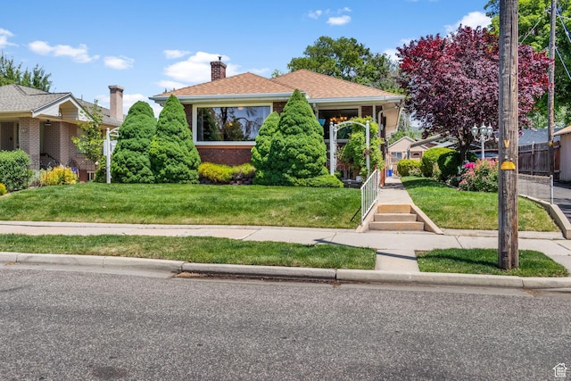 1979 S 600 E, Salt Lake City, UT 84105 - view of front facade with brick siding, a front lawn, and a chimney