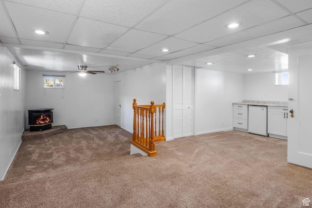 1979 S 600 E, Salt Lake City, UT 84105 - basement featuring a wood stove, light carpet, recessed lighting, plenty of natural light, and ceiling fan